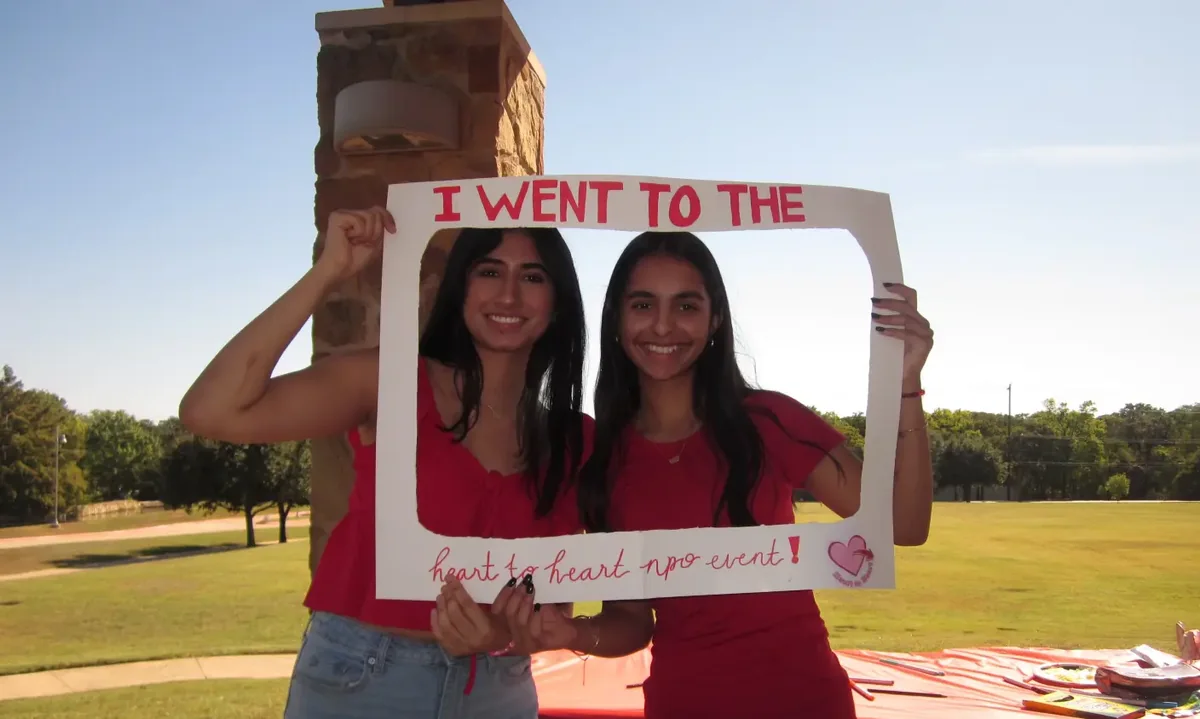 Volunteers in red at a Heart to Heart awareness event.